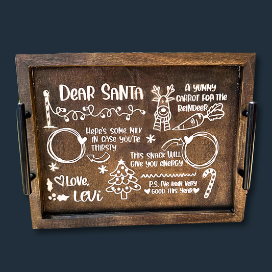 The Cookies for Santa Serving Tray is ideal for Christmas Eve, featuring spaces for milk, snacks, a reindeer carrot, and a note: P.S. I’ve been very good this year! Signed Love, Levi, it showcases festive drawings of a tree, candy cane, and reindeer for joyful holiday celebrations.