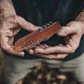 Load image into Gallery viewer, The Ultimate Gift for Him, a versatile 8-function pocket tool engraved with Jared, features handy tools like a corkscrew. Perfect for adventurers, its gripped against an outdoor backdrop, making it the ideal pocket companion for explorers.