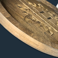 Load image into Gallery viewer, The Boho Bliss: Custom Round Serving Tray features intricate geometric carvings with a smooth surface that showcases its craftsmanship, emphasizing the natural wood grain and artful design against a dark background.